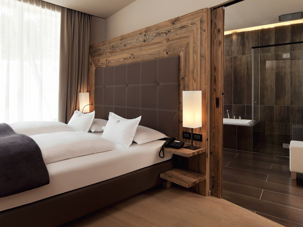 COMO Alpina Dolomites Alpina Suite bedroom and bathroom